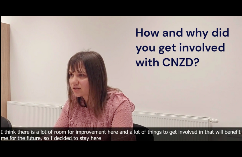 A woman in a pink shirt answers the question of how she got involved with CNZD