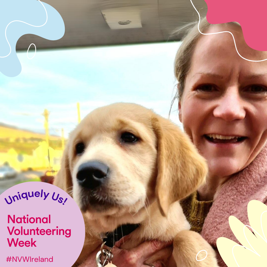 A happy woman holds an adorable golden lab puppy